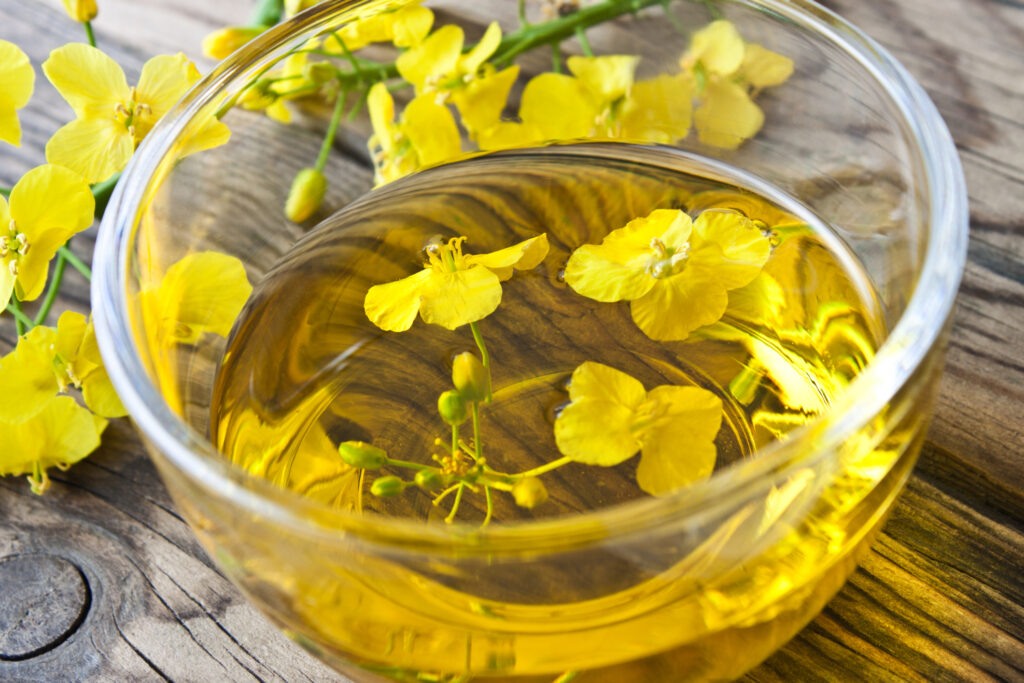 Canola oil and glass bowl with blossoms