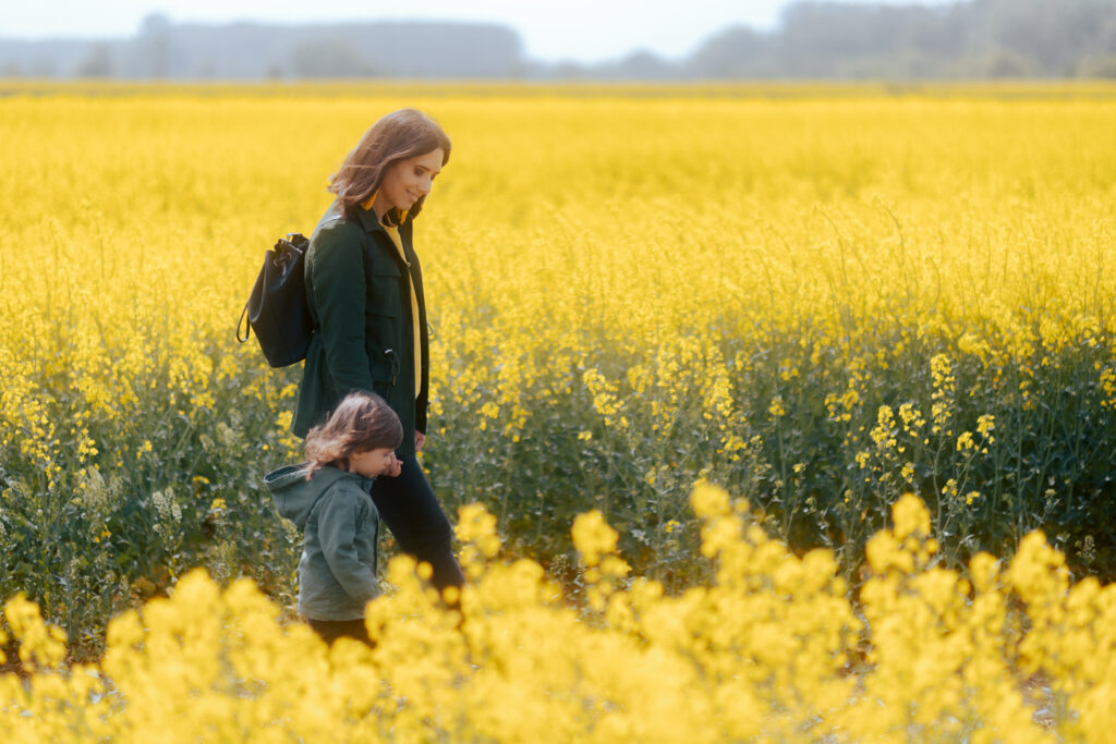 Mother and Daughter Walking in a Canola Floral Field